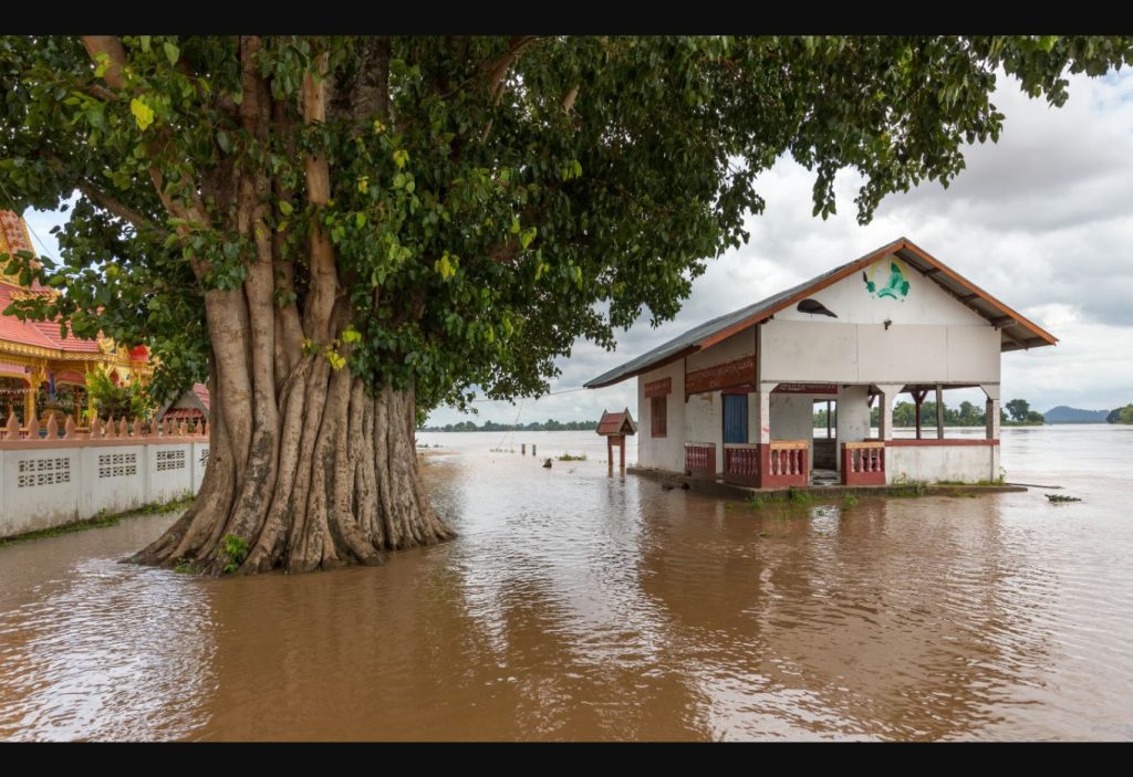 Flooded building beside the Mekong River in Si Phan Don, Laos